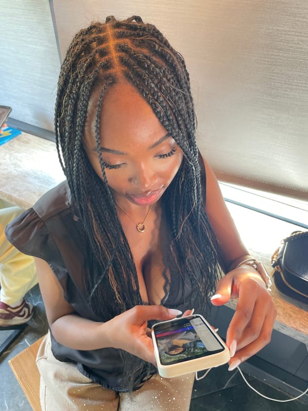 Woman checks phone at cafe during lunch hour