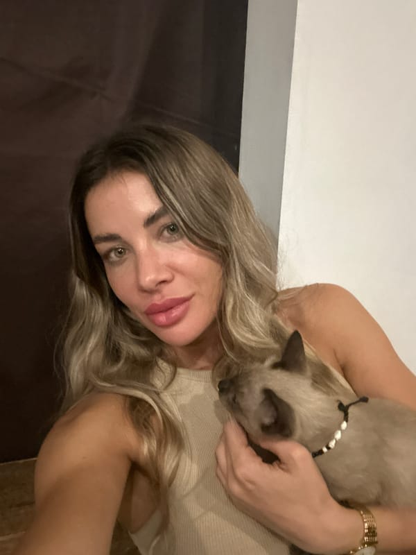Woman and cats observed in Kuta Selatan home setting