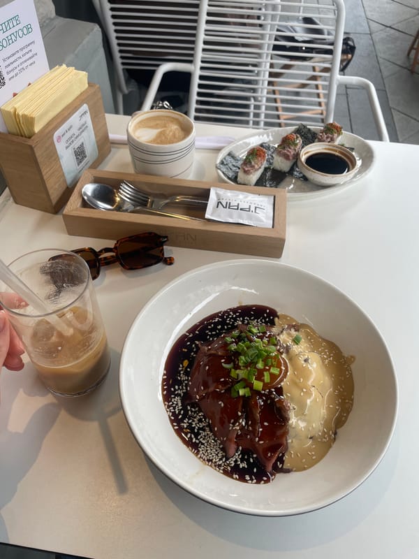 Restaurant meal documented with sauced meat dish and garnish