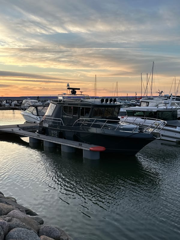 Sunset at Tallinn's marina, people and boats along the waterfront