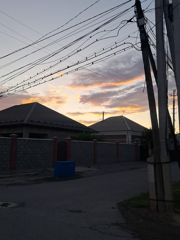 Dusk settles over a mosque and streets in Shymkent