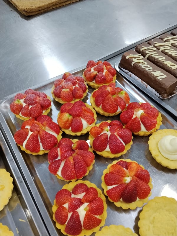 Bishkek bakery in full morning prep, pastries and fresh fruit everywhere