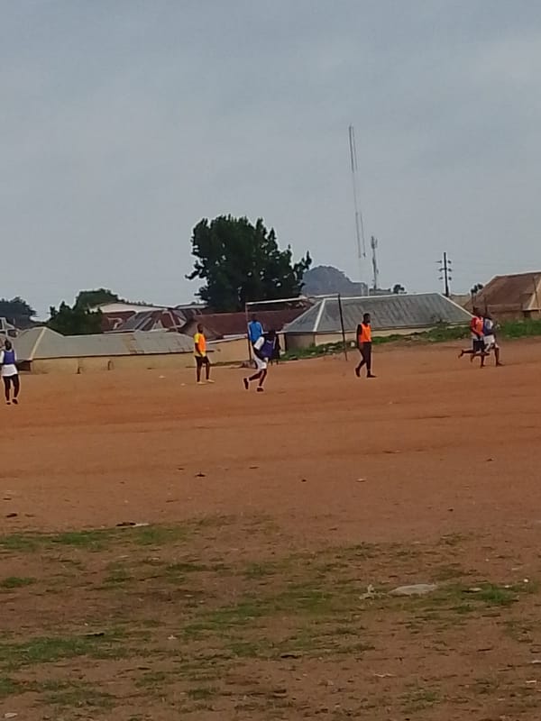 Informal soccer match played on dirt field in Bukuru