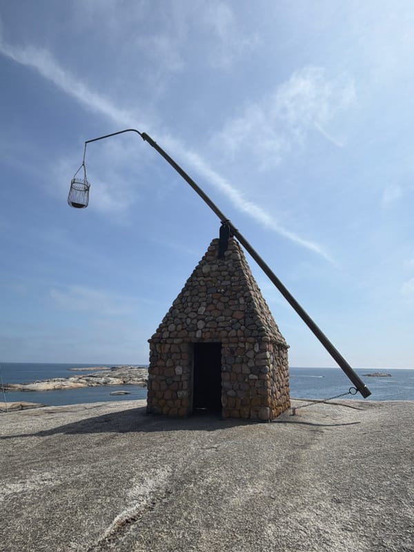 Stone beacon hut with suspended metal cage on Tjøme coast