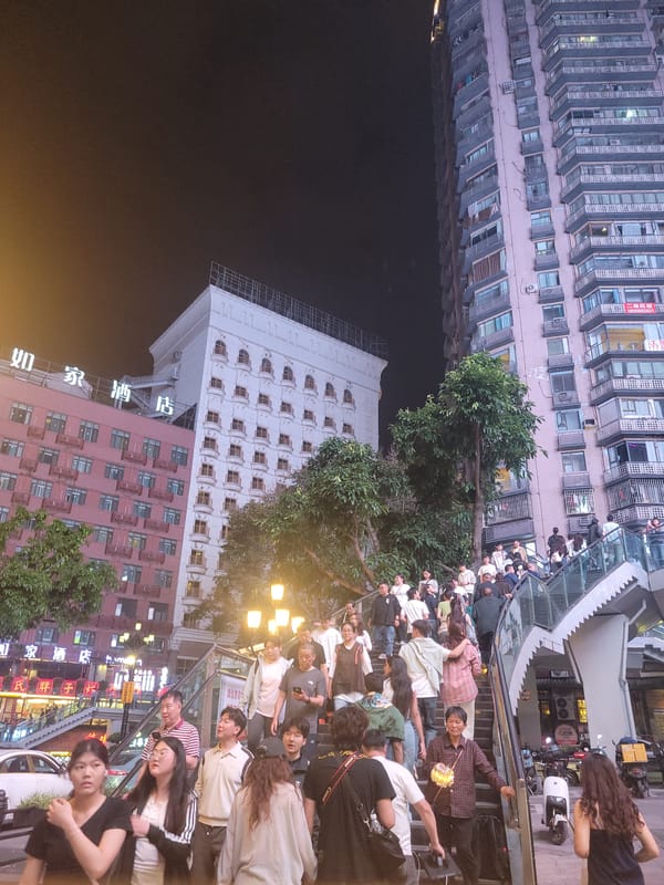 Nighttime crowds gather in illuminated Yuzhong District streets