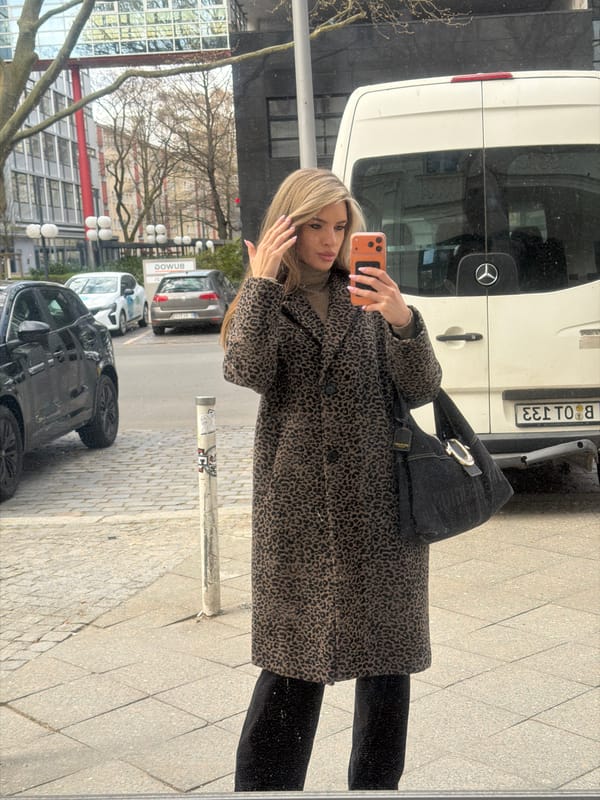 Woman takes selfie on Berlin street near Mercedes van