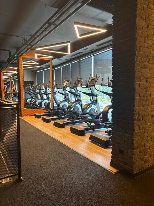 Inside a modern Plovdiv gym with cardio equipment and virtual ride screens