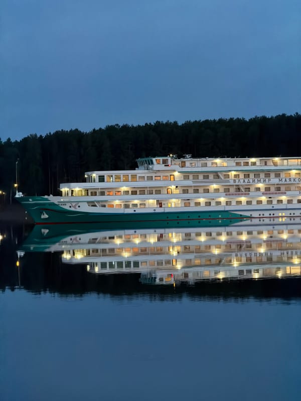 Evening fishing and cruise ship activity in Chaikovsky, Russia