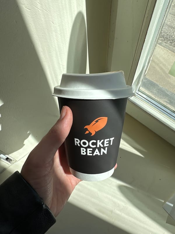 Coffee cup with rocket logo photographed in Riga