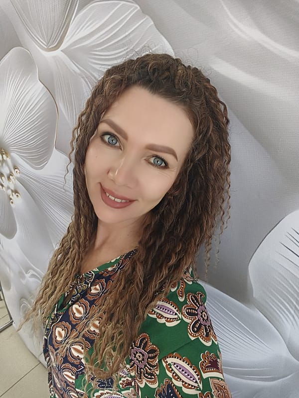Woman photographed in bedroom wearing green patterned shirt
