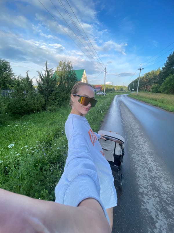 Stroller walk selfies on a wet rural road in Podshivalovo