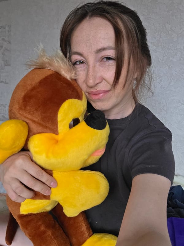 Woman holds plush lion toy indoors