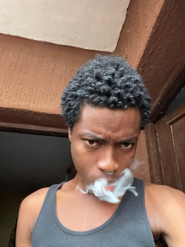 Outdoor portrait series in Nkpor, Nigeria, with smoking.