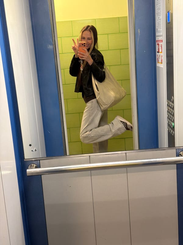 Mirror selfie with an orange phone in Khimki