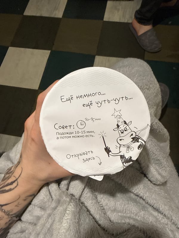 Moscow resident holds whimsical Russian product with wizard cow illustration