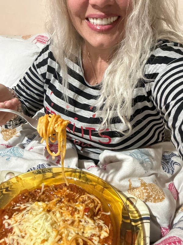 Woman enjoys spaghetti dinner with strawberries in Sofia