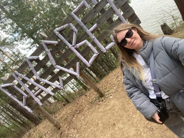 Woman walks Jack Russell Terrier by lake in Noviy, Russia