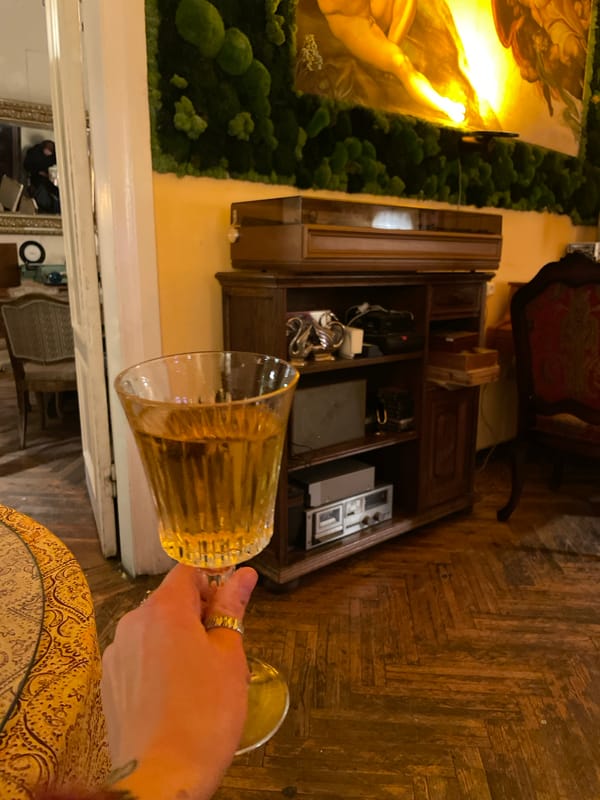 Person enjoys beverage at decorated dining table in Tbilisi
