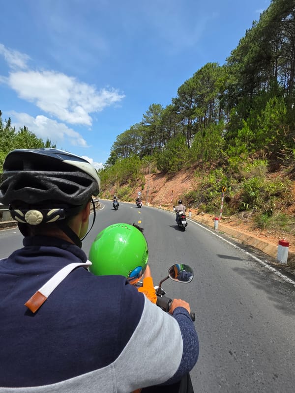 Motorcycle riders travel through Thôn 5 Vietnam early morning