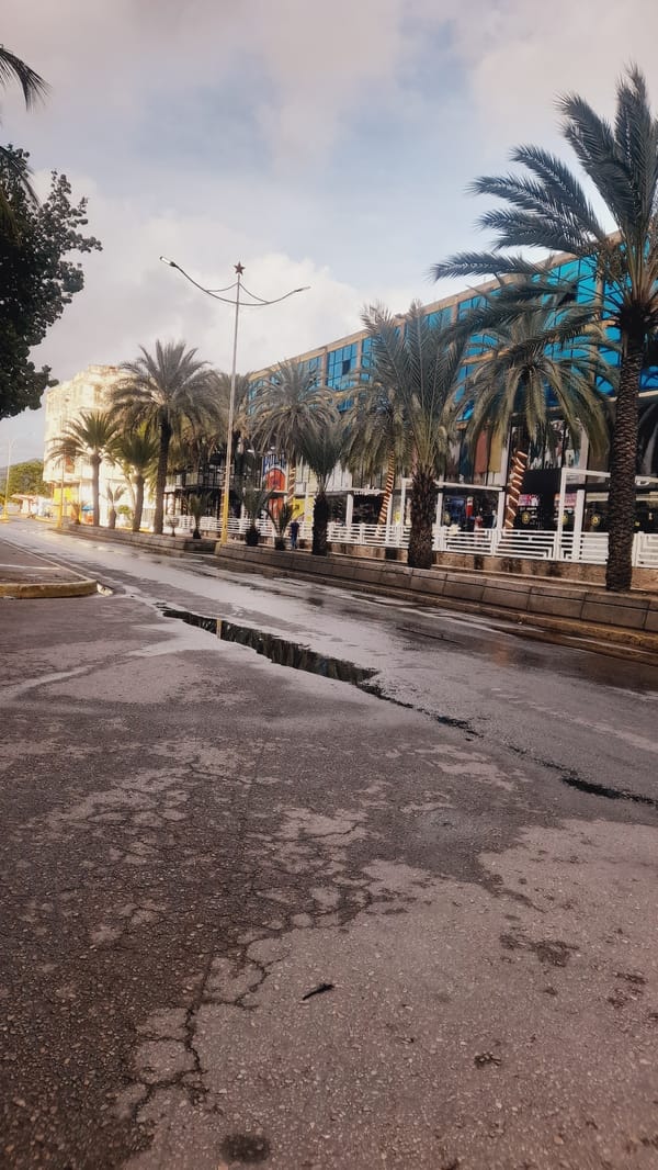 Cracked, flooded street in Juan Griego after rain