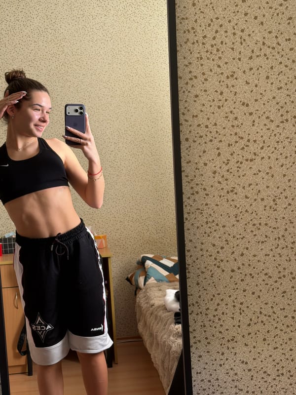Woman takes mirror selfies in athletic wear, Sofia
