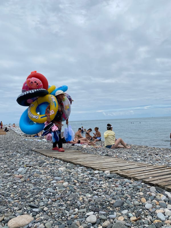 Cloudy morning on Batumi's pebble beach and boulevard