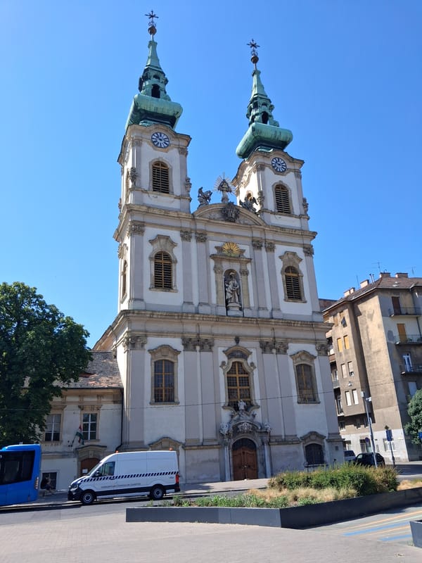Baroque church and a resting dog on a sunny Budapest morning