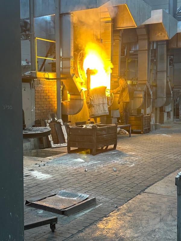 Metal workers operate furnace equipment in Russian industrial facility