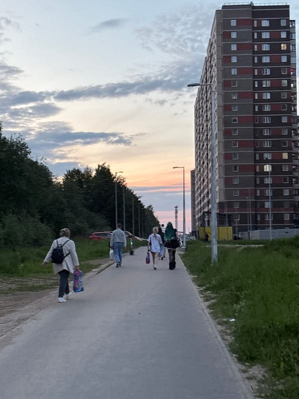 Young skateboarders gather at dusk in Sinyavino residential area