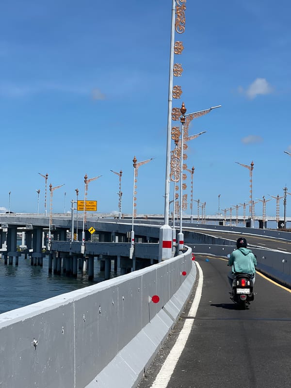 Crossing Kuta's coastal overpass on a sunny, breezy morning