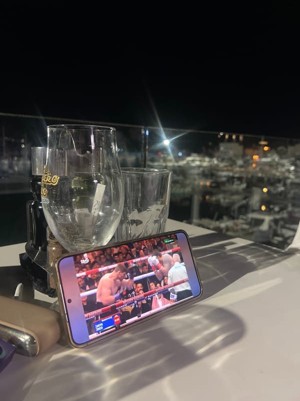Boxing match viewed on phone with beer glasses in Budva