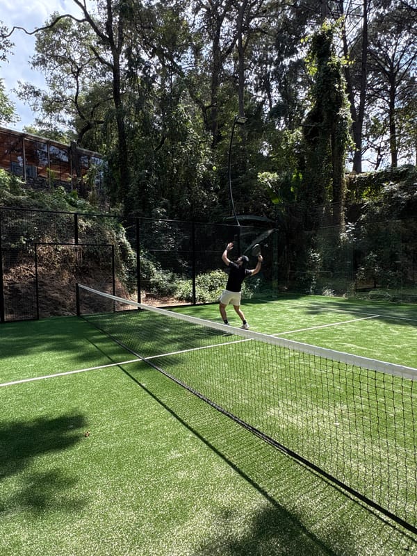 Tennis player hits ball on court in Valle de Bravo