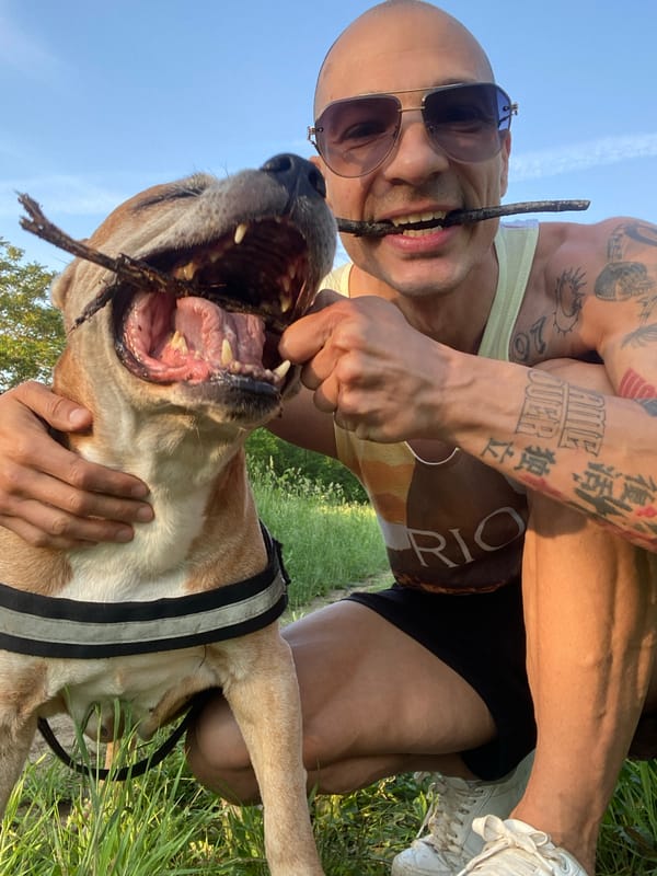 Man and dog pose with sticks in Pleven