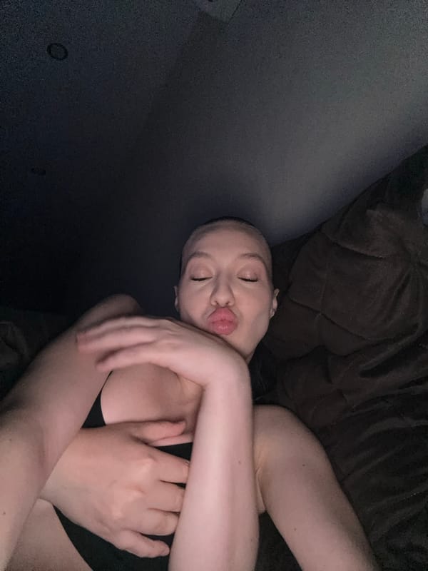 Close-up portrait, eyes closed, lips puckered for a kiss.
