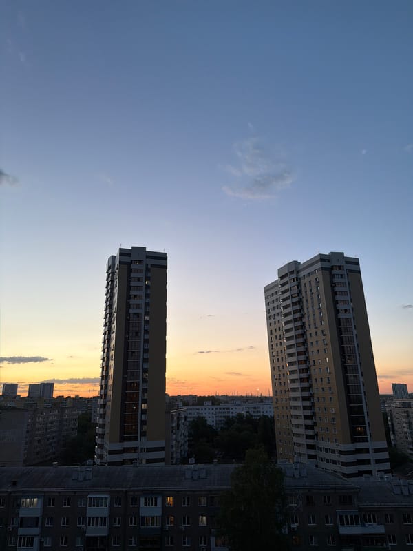 Urban dusk captured at residential towers with lit windows