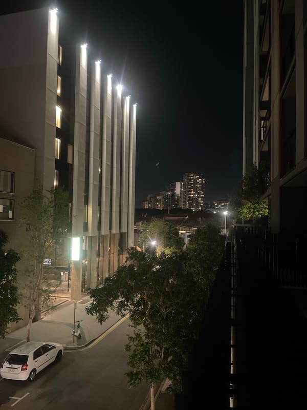 Brisbane night: city streets, a balcony, and cozy interiors