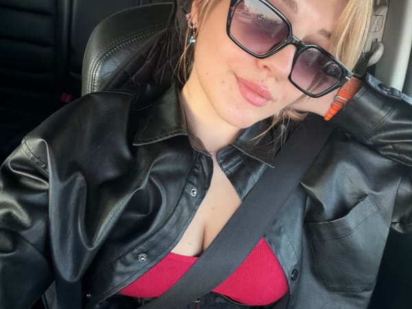 Woman in sunglasses observed traveling by vehicle in Naberezhnye Chelny