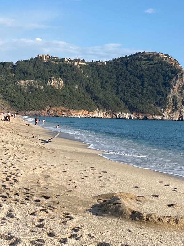 Beachgoers enjoy sunny afternoon leisure activities in Alanya, Turkey