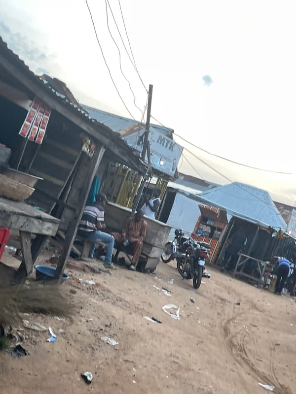 Everyday street life in a dusty rural African settlement