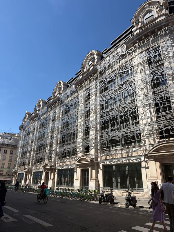 Tourist documents classic Parisian architecture during afternoon walking tour