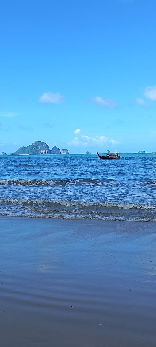 Tourist documents early morning Thai beach exploration near Ao Nang