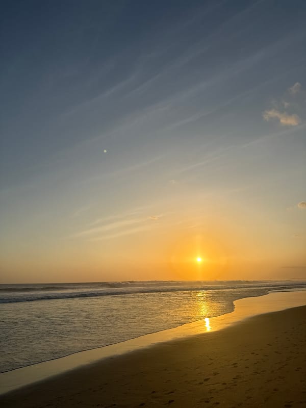 Sunset over North Kuta beach, soft gradients and wispy clouds