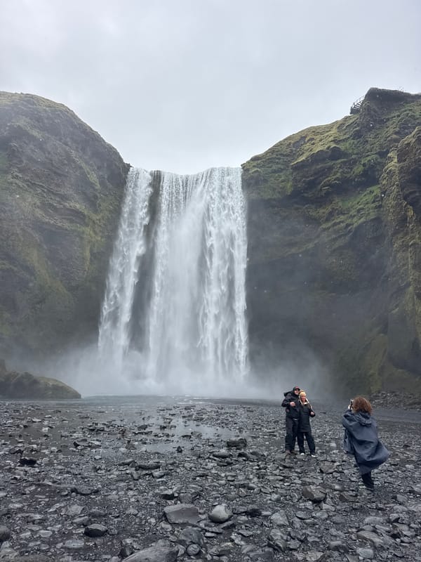 Tourist documents typical day at Iceland's Skógafoss waterfall