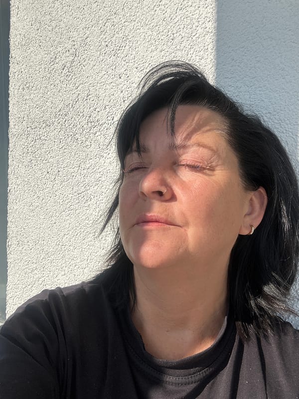 Woman rests outdoors in sunlight in Russian village