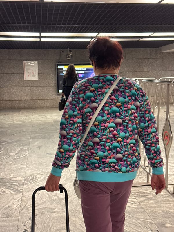 Moscow Metro station — green-lit arches, luggage, morning transit