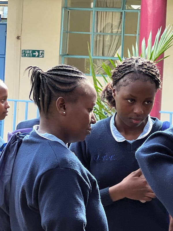 School students gather outdoors in uniforms in Nyeri