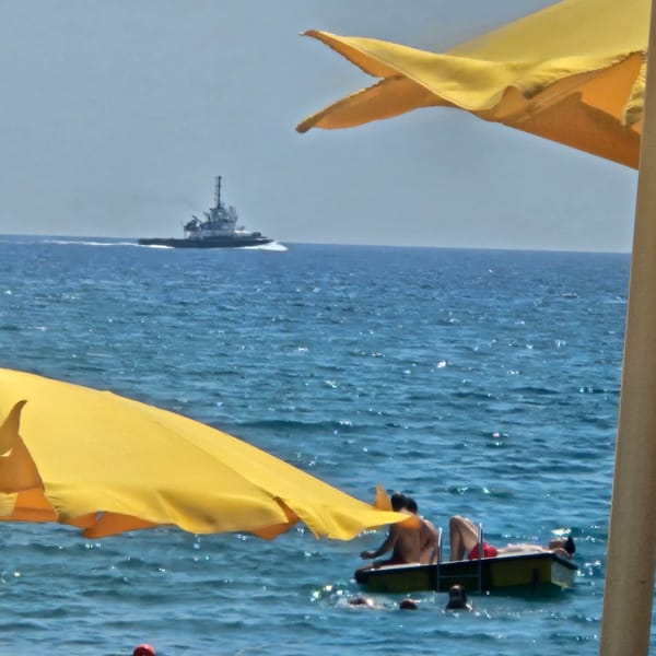 Catamaran launch, kites, and beach life in Savona