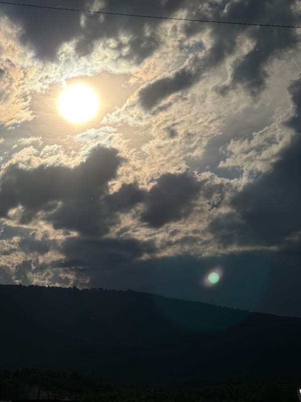Rural roads and village life under dramatic shifting skies