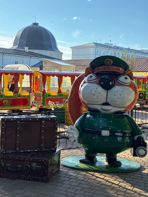 Statues, miniature buildings, and Ferris wheels at a theme park