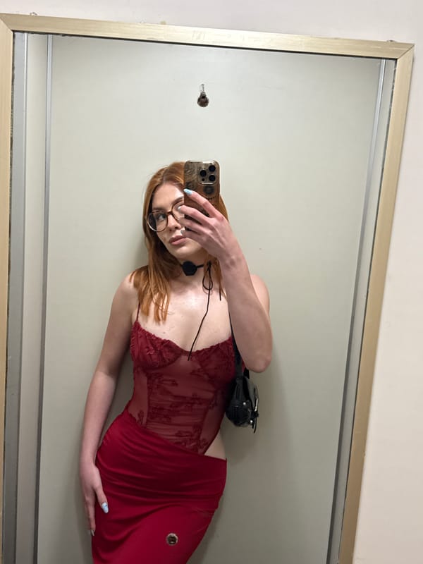 Woman takes mirror selfie in red dress, Sanremo